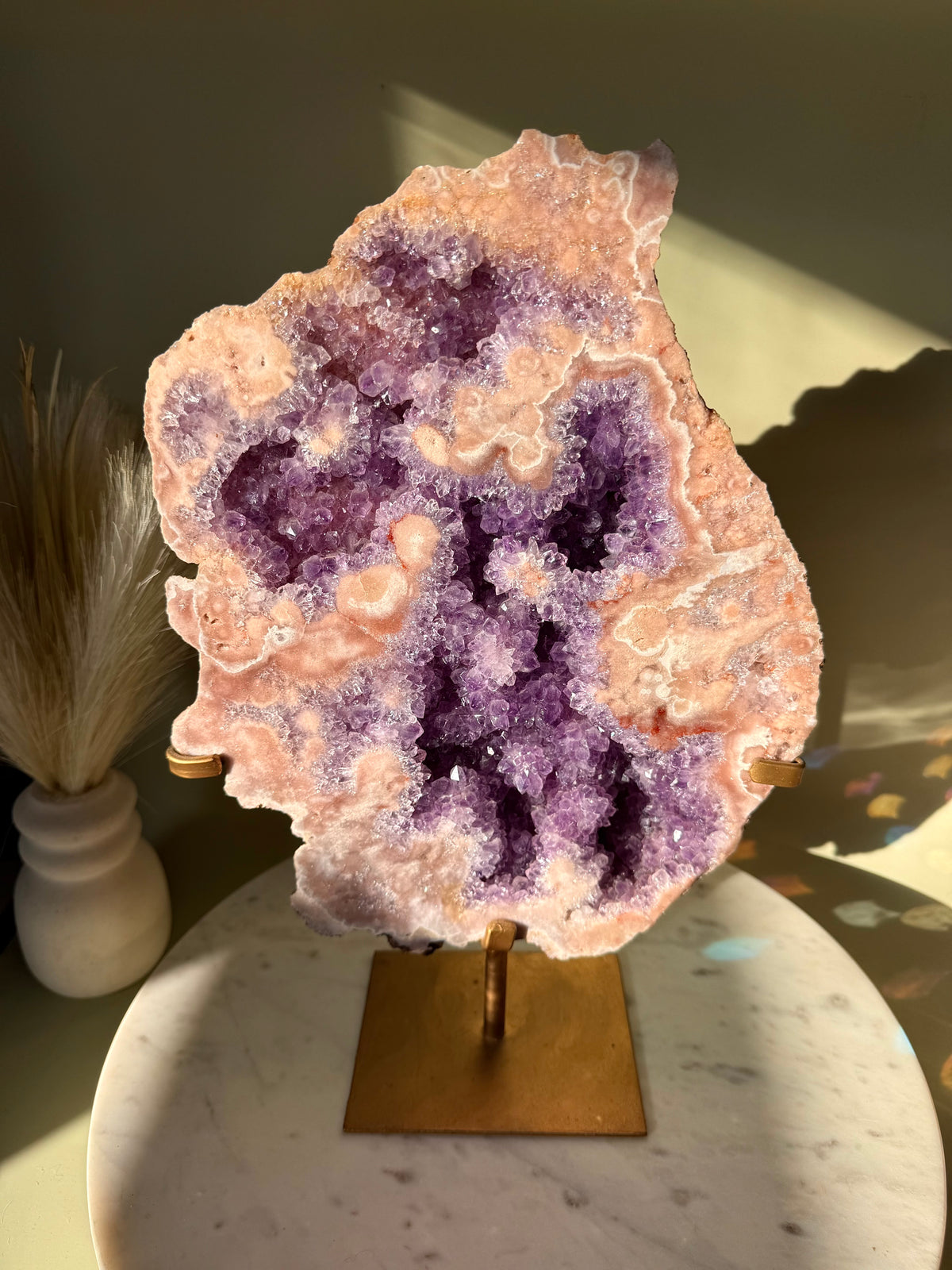Museum grade pink amethyst geode slice on custom stand.